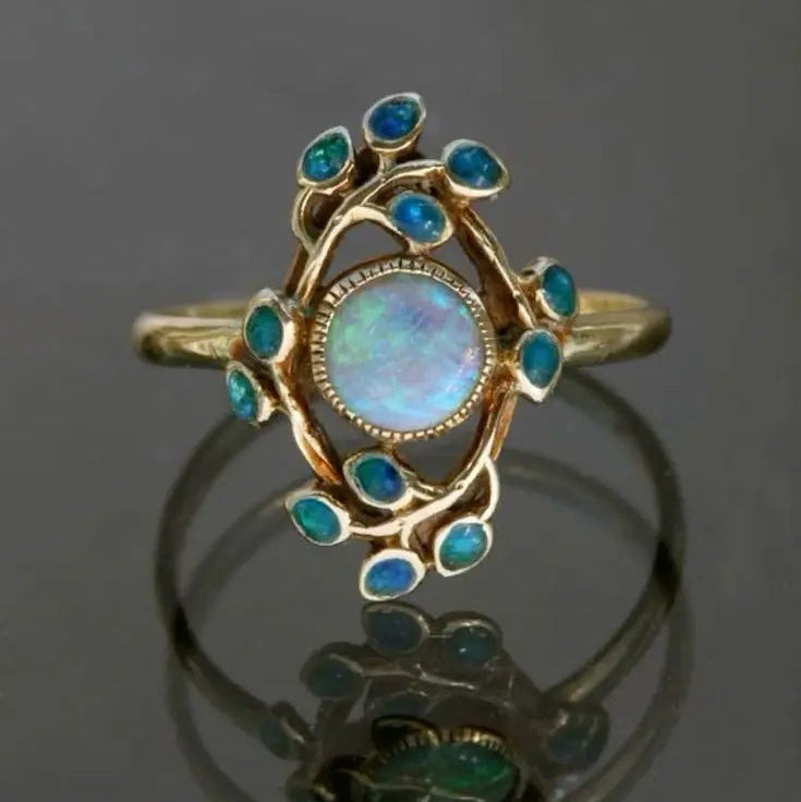 Anillo retro azul con cristales y ópalo